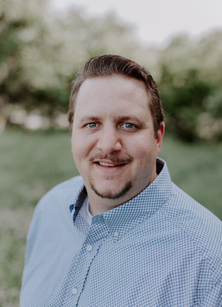 Jed, owner of Custom Marriage Services, which offers his officiant services for weddings. He is a preferred vendor for VOW.